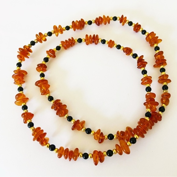 Genuine amber vintage bead necklace with gold and black stone beads. 22”